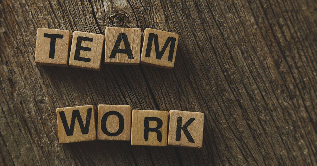 a photo of building blocks spelled out a teamwork on a table