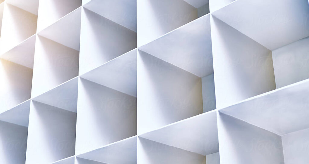 Abstract architectural image illustrating a grid of three-dimensional, geometric shapes with square openings, echoing the principles of building a sustainable talent strategy through patterns of light and shadow on a white surface.