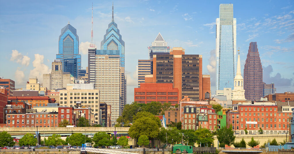 city view of Philadelphia from the Delaware River including building such as The Comcast Center and Liberty Place