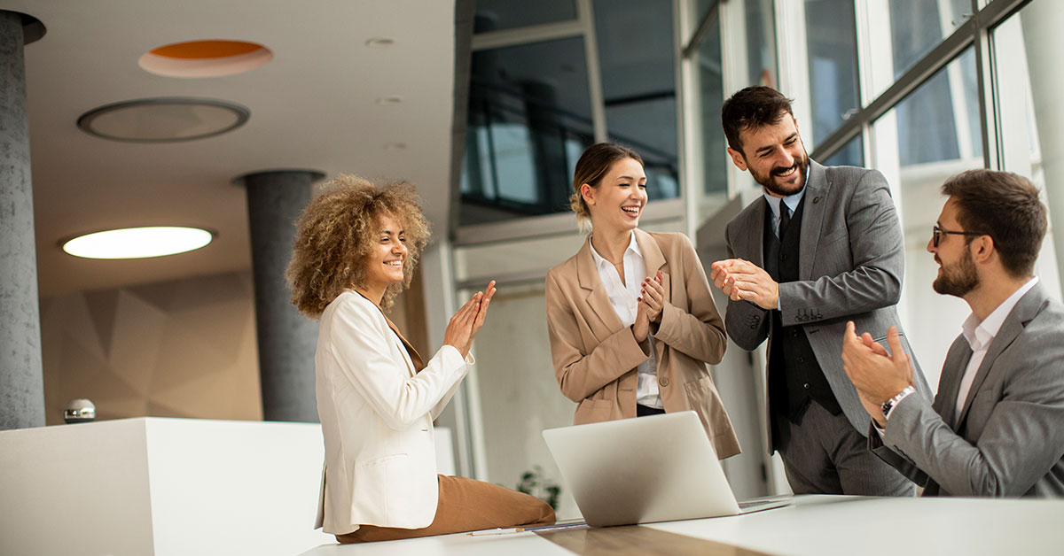 co-workers clapping for their fellow employee