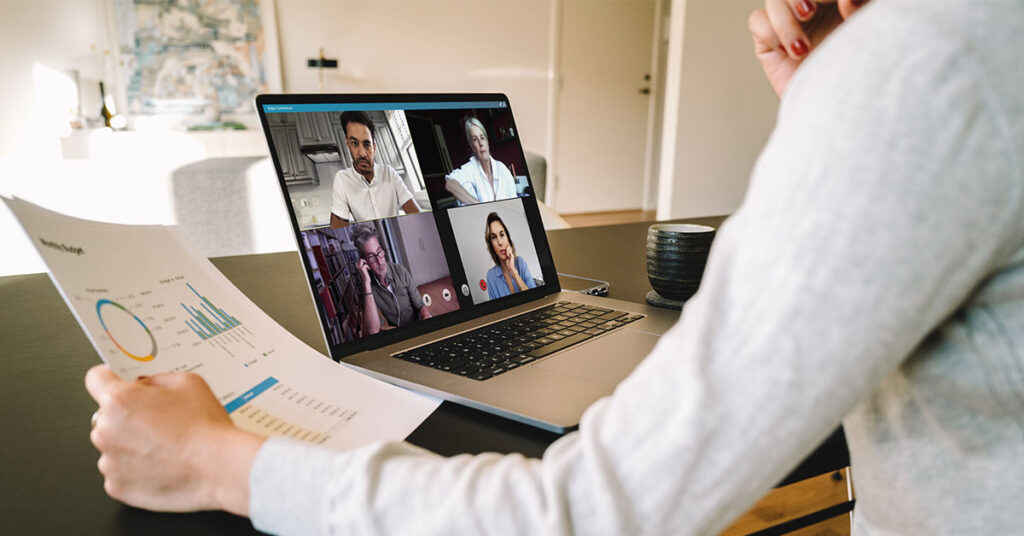 women analyzing data while speaking to her team on the computer