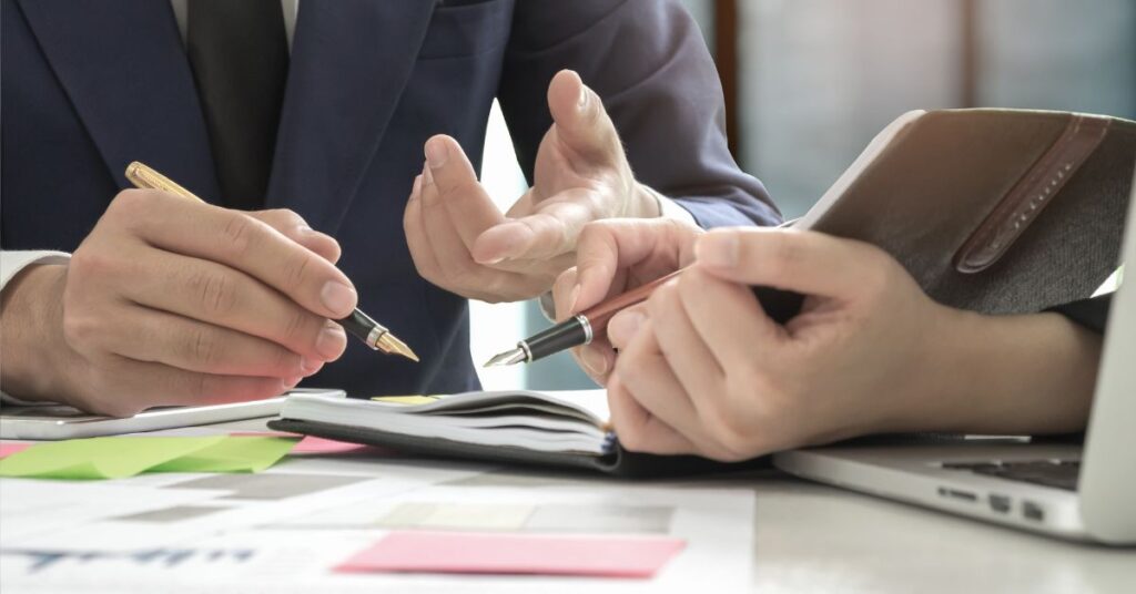 two peoples' hands zoomed in discussing work